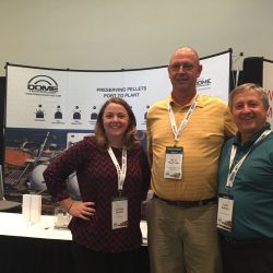 Michael Partridge, center, stands alongside USIPA vice president of policy and operations Jessica Brooks, left, and Dome Technology sales manager Lane Roberts, right, after winning Dome Technology's mini iPad drawing. Dome Technology has sponsored USIPA's annual Exporting Pellets Conference since it began five years ago.